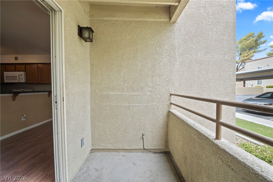 3145 East Flamingo Road, Unit 1055 Las Vegas, NV 89121 - Photo 34 of 40 A modest patio offers a private outdoor space overlooking the community parking area.