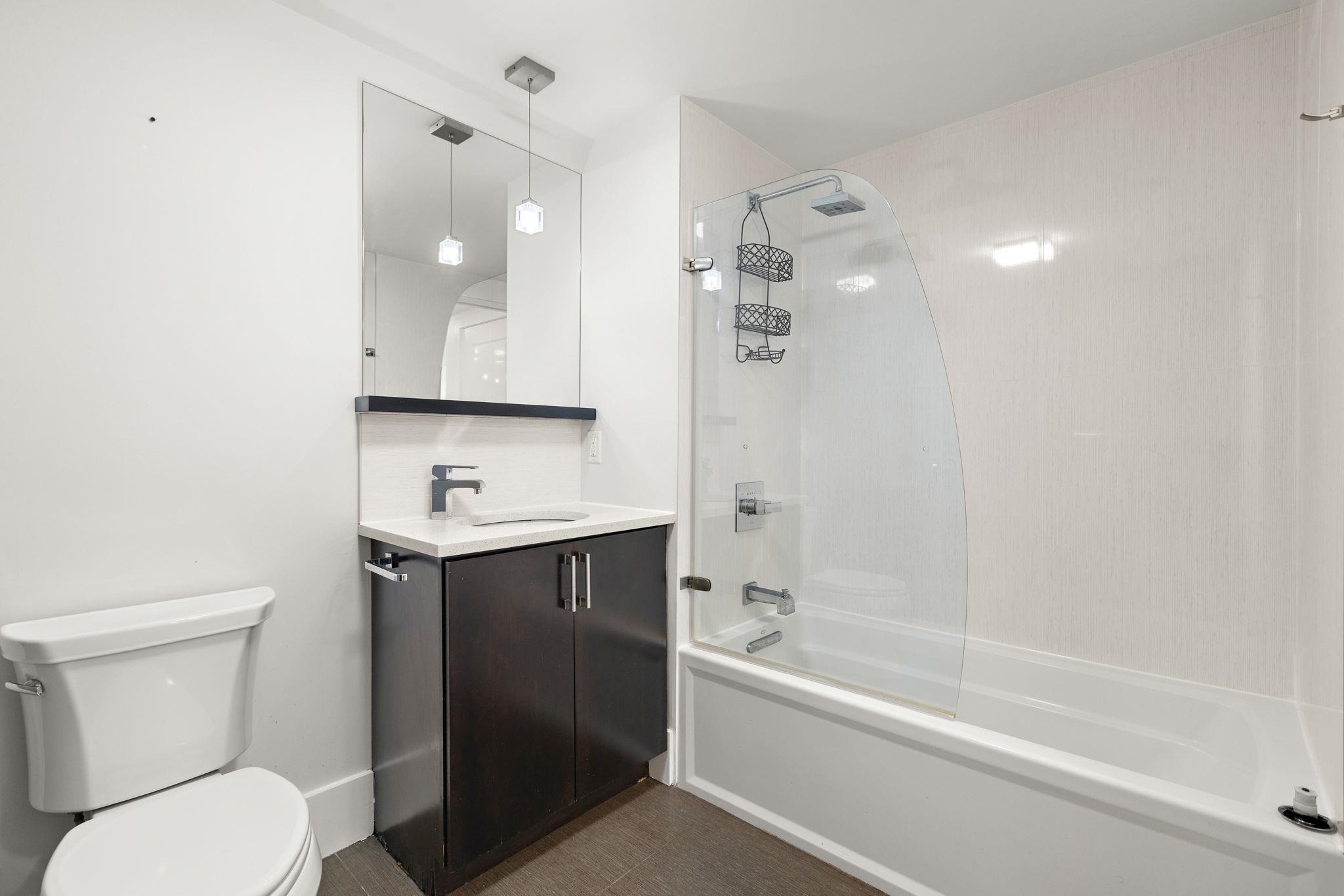 89 Jefferson Street, Unit 4B Hoboken, NJ 07030 - Photo 13 of 16 a bathroom with a sink a toilet and shower