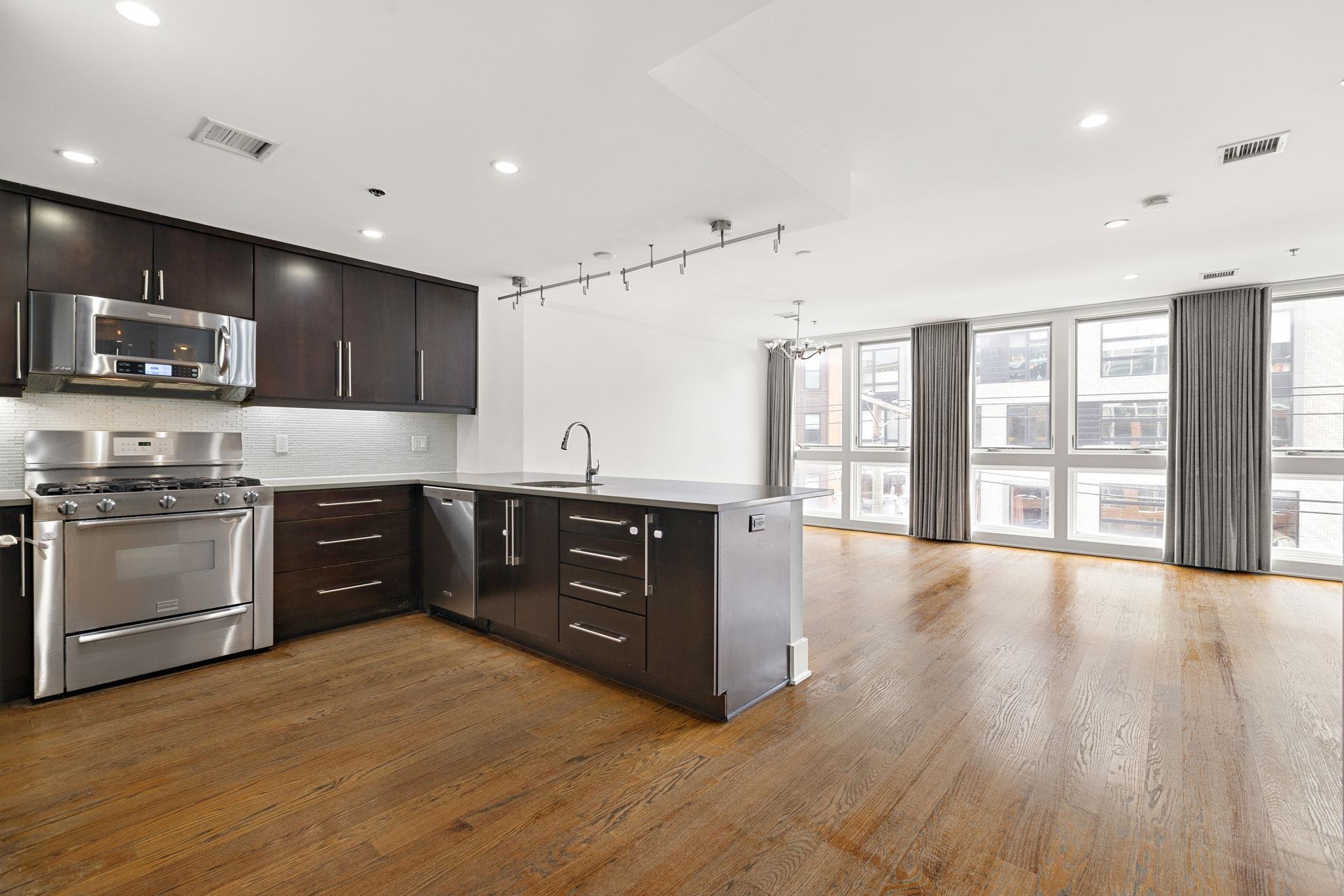 89 Jefferson Street, Unit 4B Hoboken, NJ 07030 - Photo 2 of 16 a kitchen with stainless steel appliances granite countertop a stove a sink and a microwave