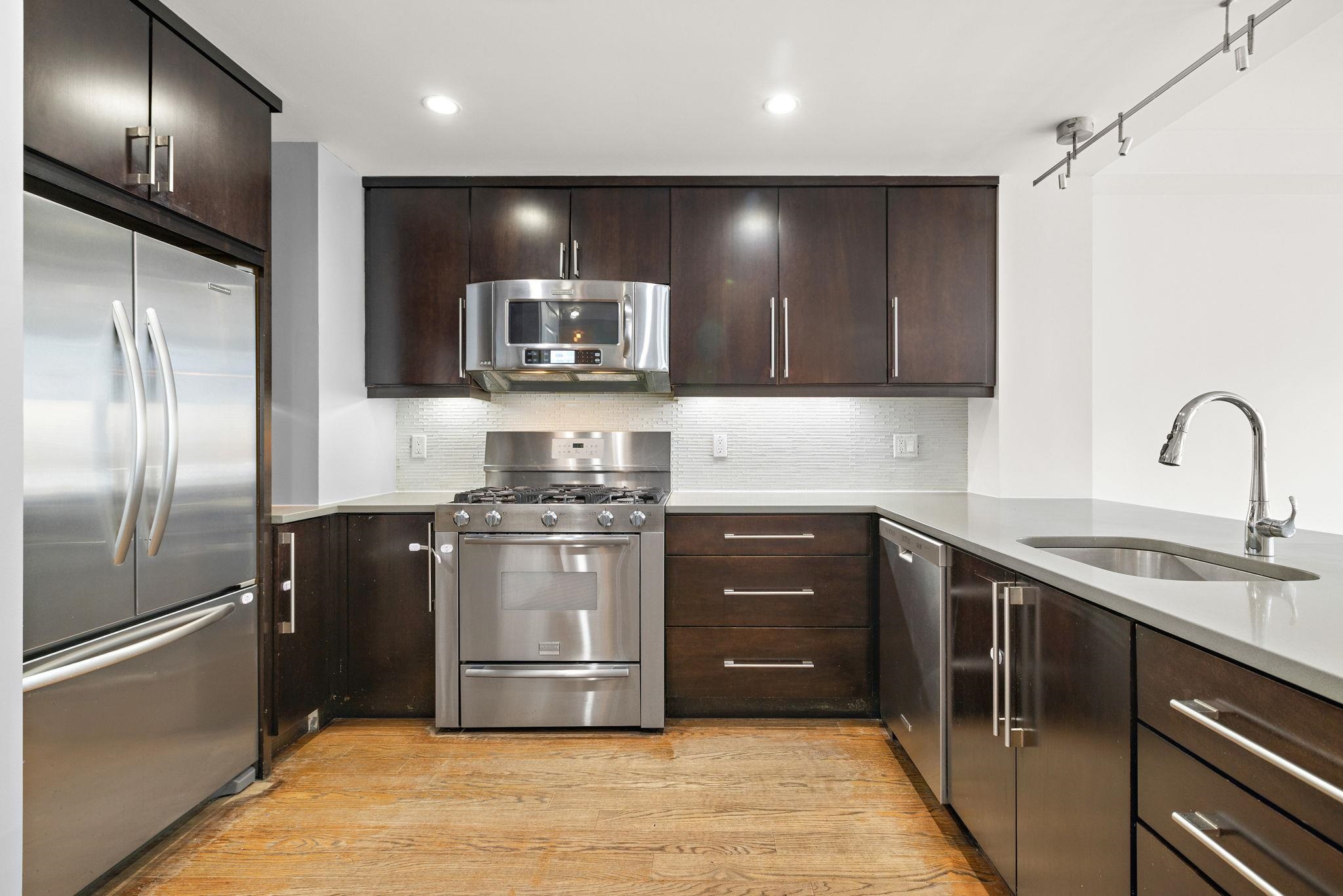 89 Jefferson Street, Unit 4B Hoboken, NJ 07030 - Photo 3 of 16 a kitchen with stainless steel appliances granite countertop a sink and a refrigerator