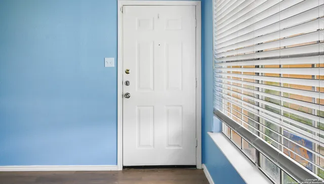 a view of a kitchen with wooden floor and a ceiling fan