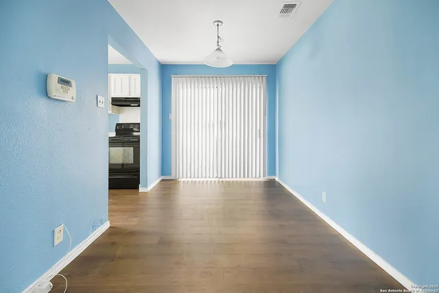 a kitchen with granite countertop white cabinets and black appliances