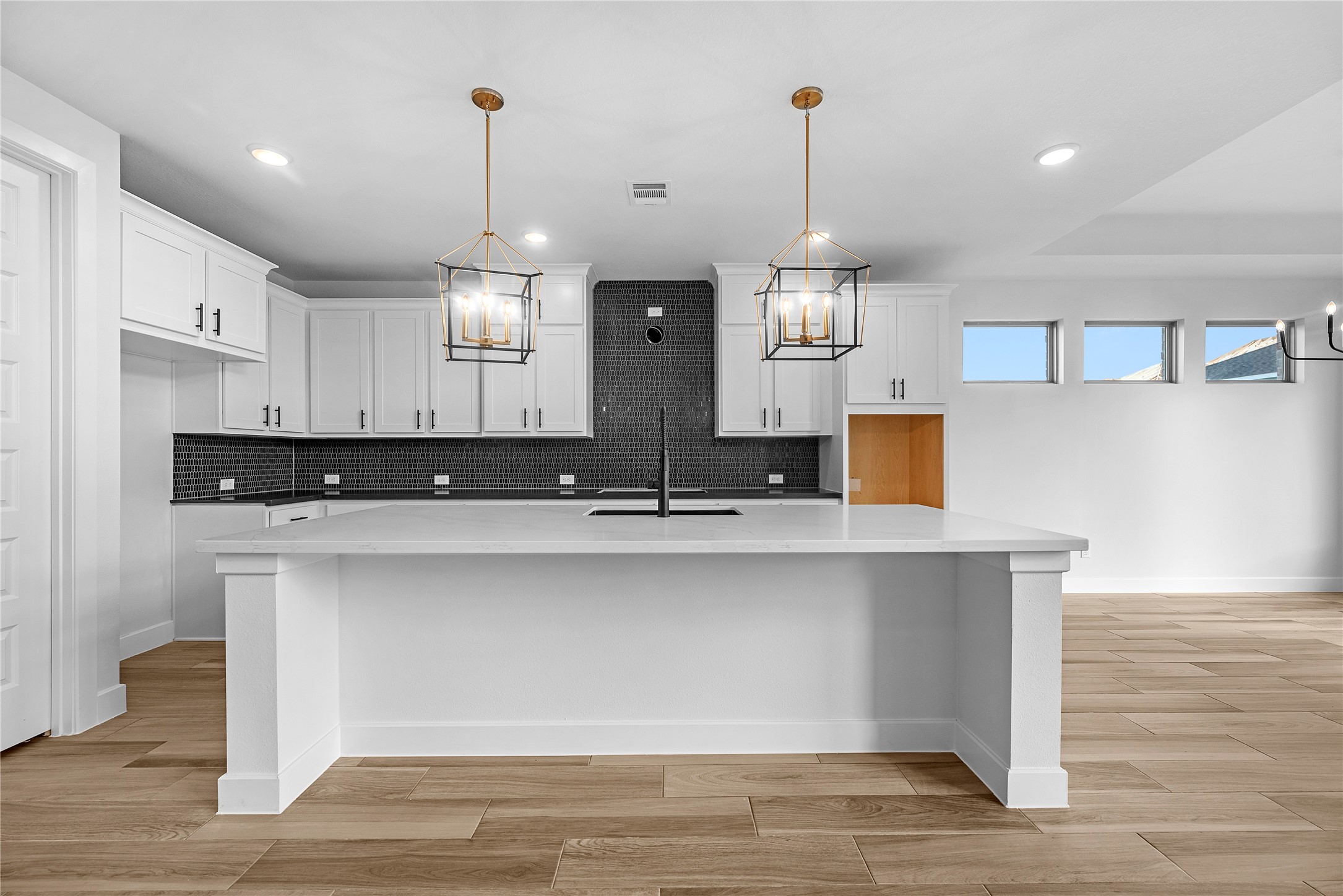 615 Roland Lane Rosenberg, TX 77471 - Photo 5 of 26 a view of a kitchen with kitchen island a sink wooden floor and refrigerator