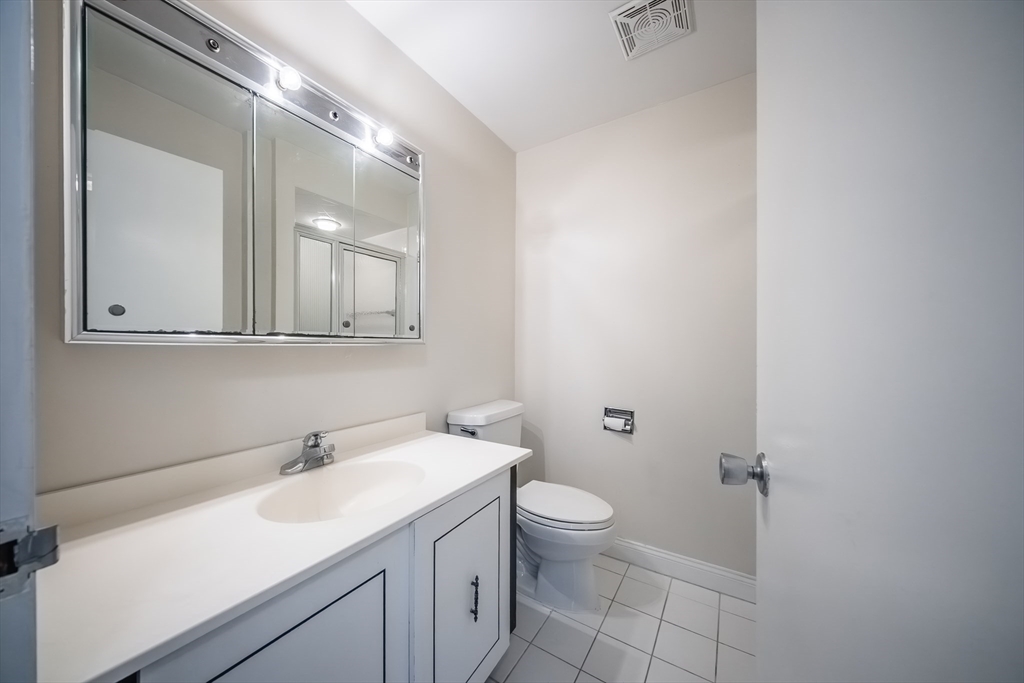 1002 Paradise Road, Unit PHE Swampscott, MA 01907 - Photo 18 of 23 a bathroom with a sink and mirror with toilet