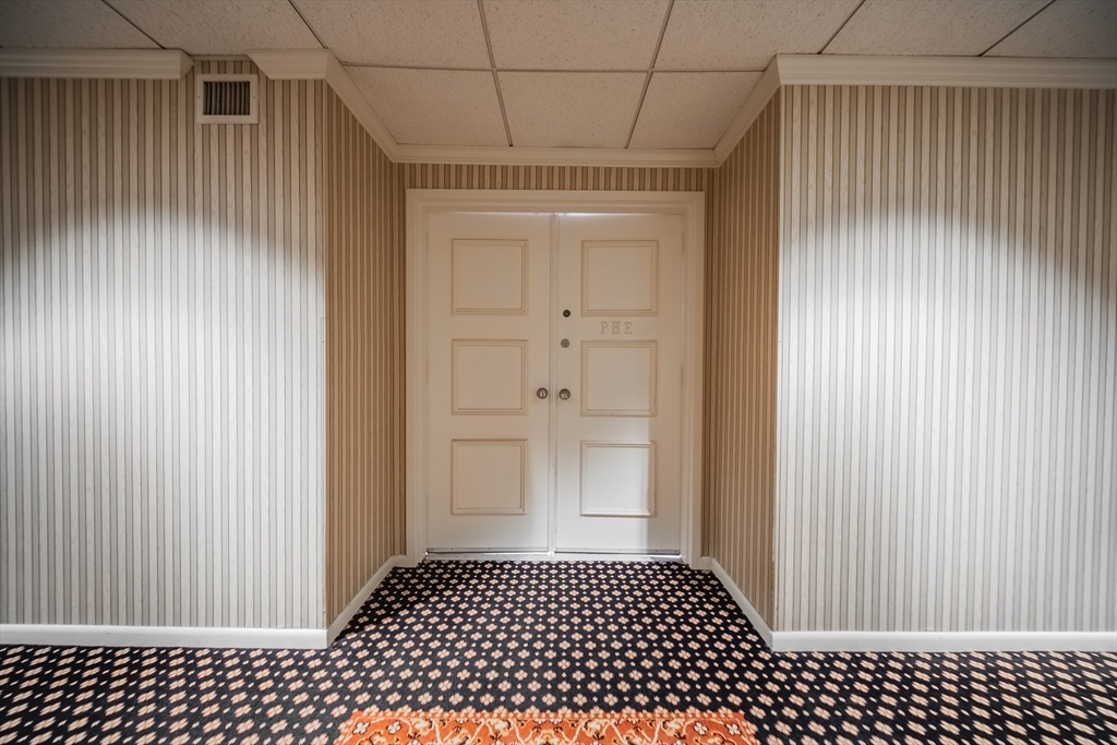 1002 Paradise Road, Unit PHE Swampscott, MA 01907 - Photo 20 of 23 a view of a utility room with wooden cabinet