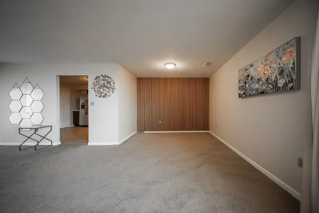 a view of an empty room and a window