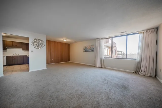 an empty room with windows and closet