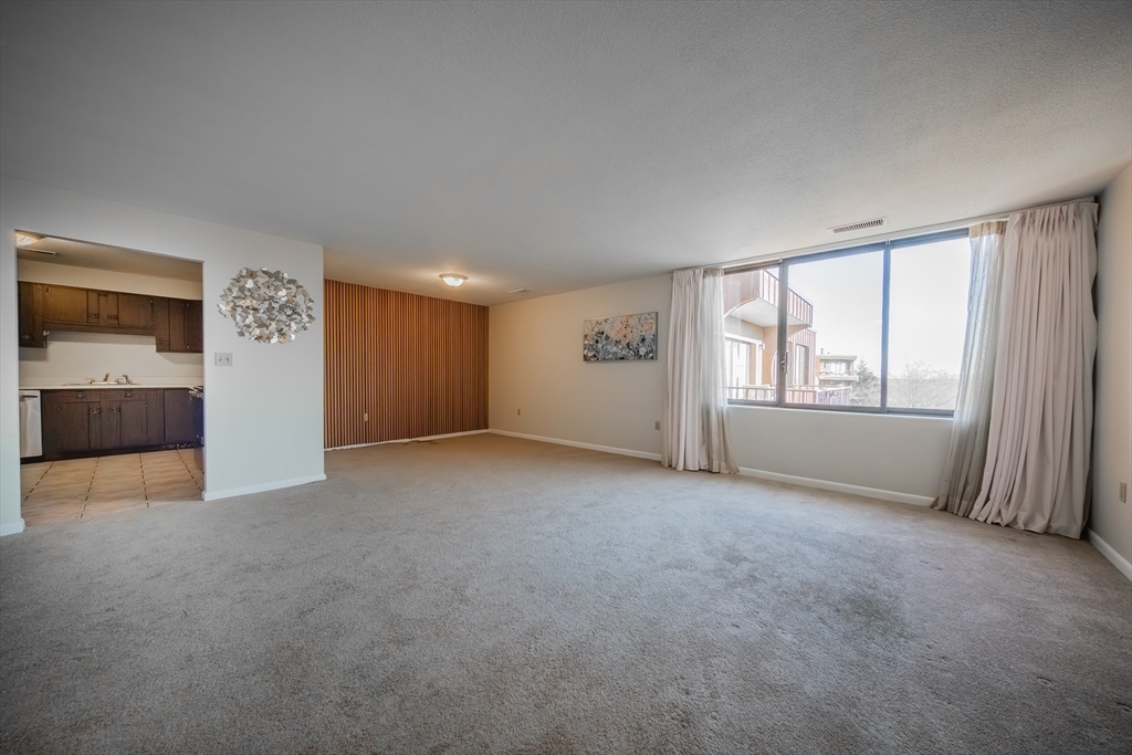 1002 Paradise Road, Unit PHE Swampscott, MA 01907 - Photo 6 of 23 an empty room with windows and closet
