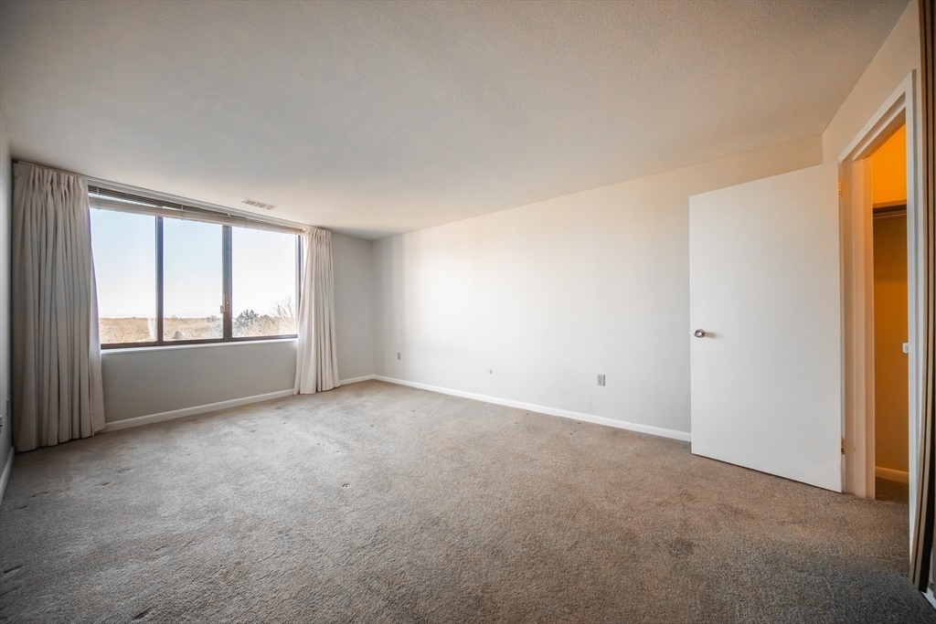 1002 Paradise Road, Unit PHE Swampscott, MA 01907 - Photo 7 of 23 a view of an empty room with a window