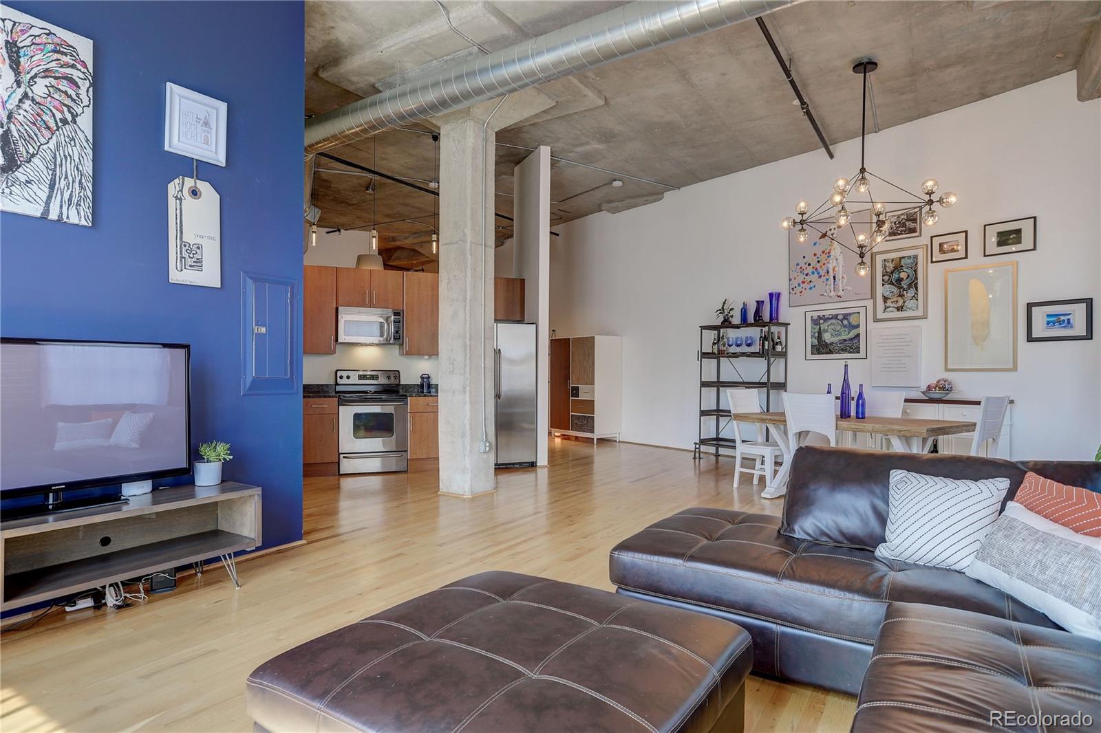 2500 Walnut Street, Unit 212 Denver, CO 80205 - Photo 1 of 39 a living room with furniture a chandelier and a dining table