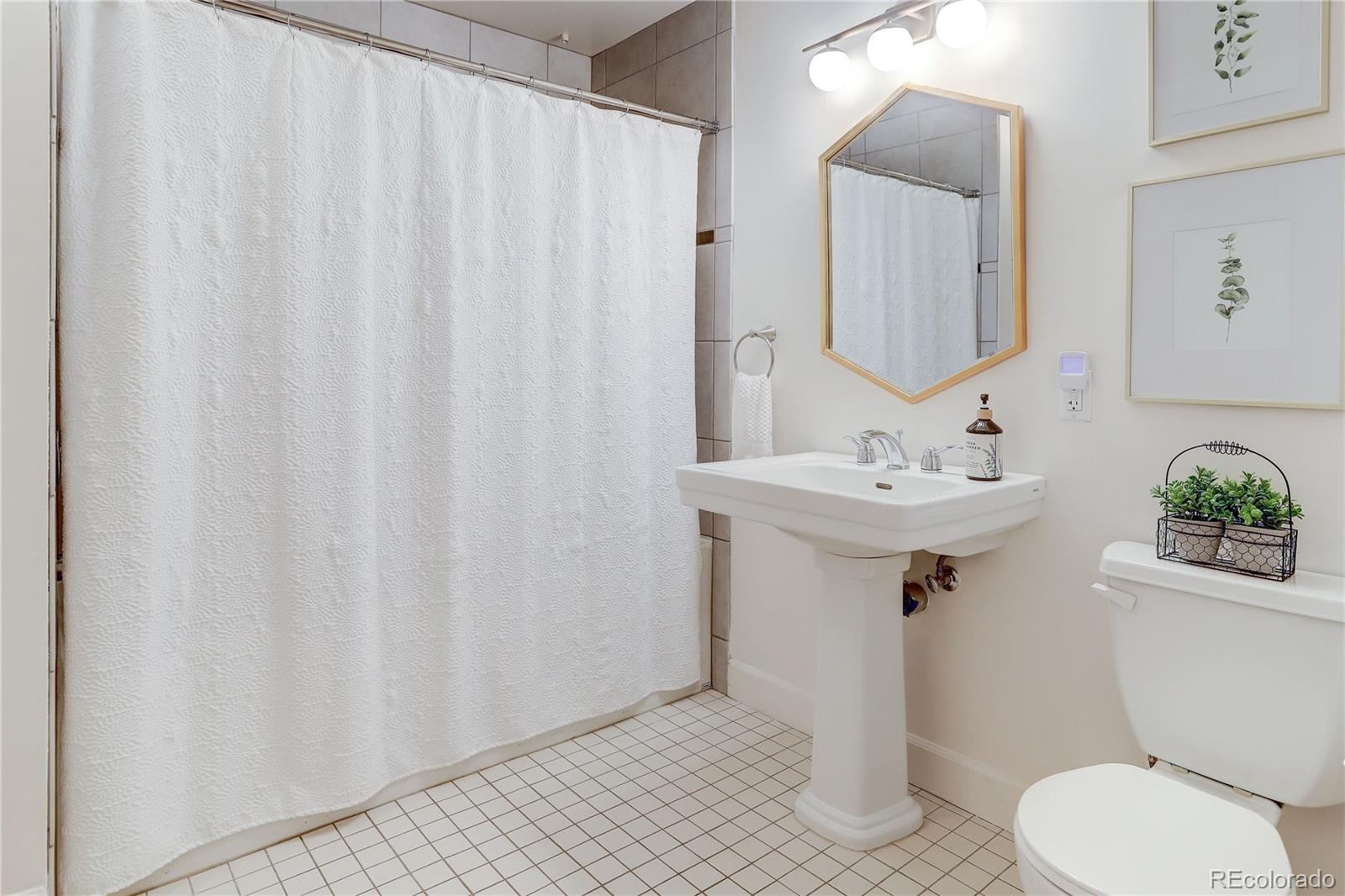 2500 Walnut Street, Unit 212 Denver, CO 80205 - Photo 14 of 39 a bathroom with a sink toilet and shower
