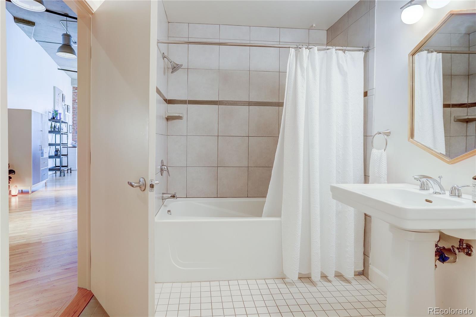 2500 Walnut Street, Unit 212 Denver, CO 80205 - Photo 16 of 39 a bathroom with a sink a toilet and shower
