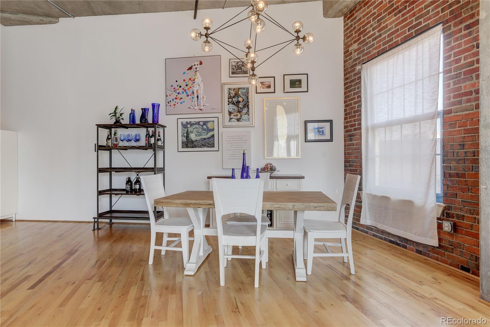 2500 Walnut Street, Unit 212 Denver, CO 80205 - Photo 22 of 39 a view of a dining room with furniture and wooden floor