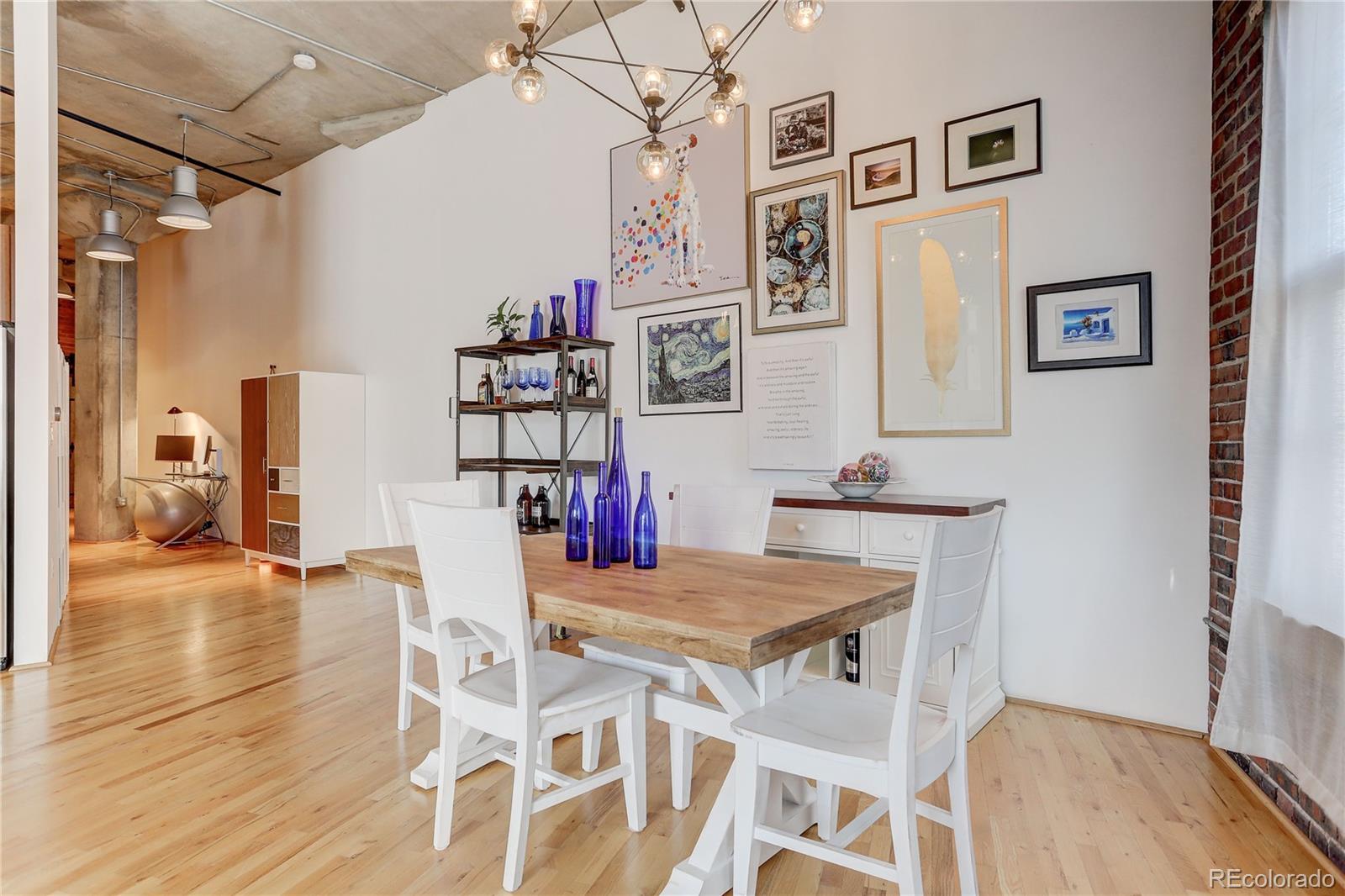 2500 Walnut Street, Unit 212 Denver, CO 80205 - Photo 23 of 39 a view of a dining room with furniture and wooden floor