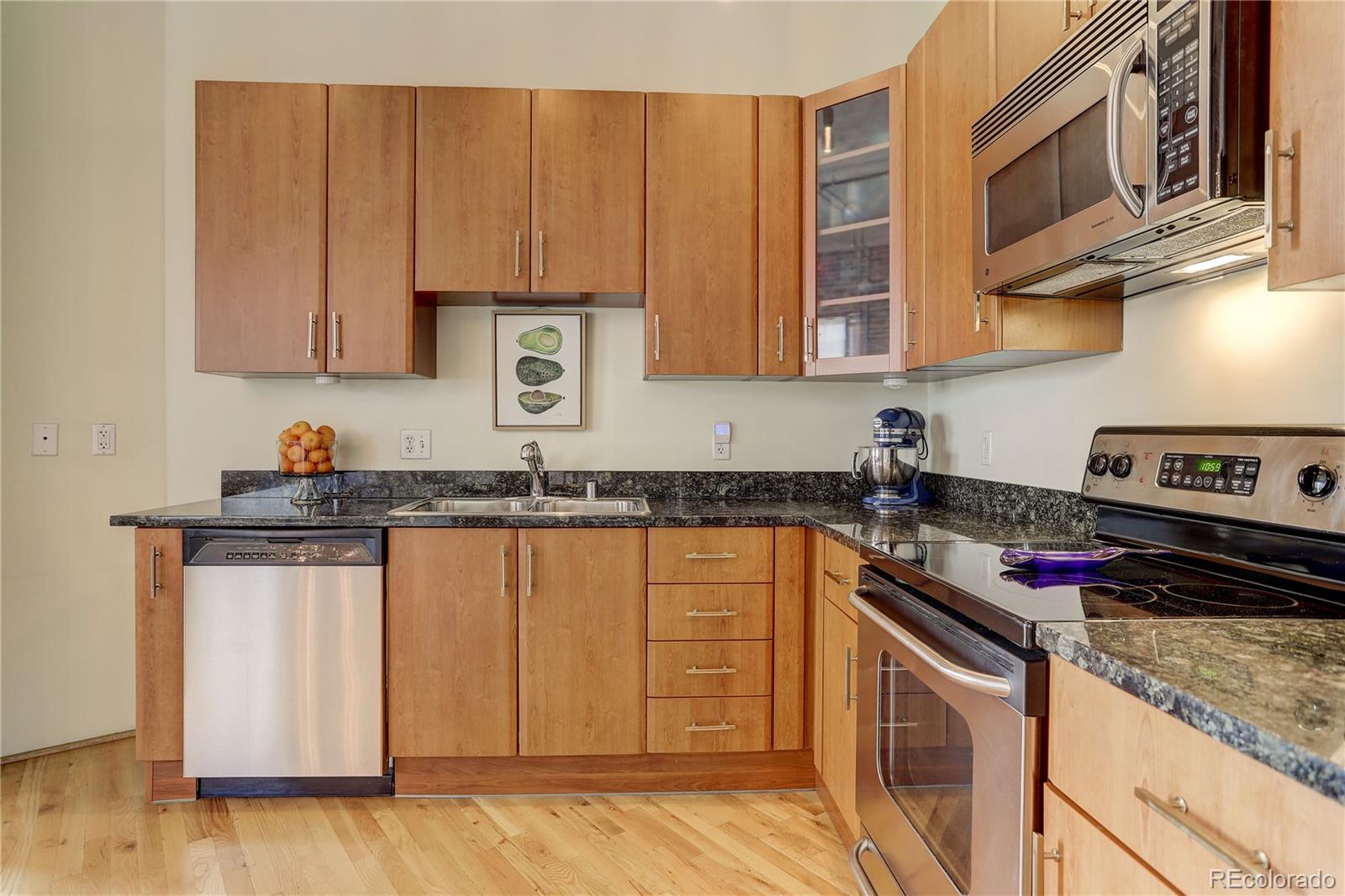 2500 Walnut Street, Unit 212 Denver, CO 80205 - Photo 26 of 39 a kitchen with stainless steel appliances granite countertop a sink stove and cabinets