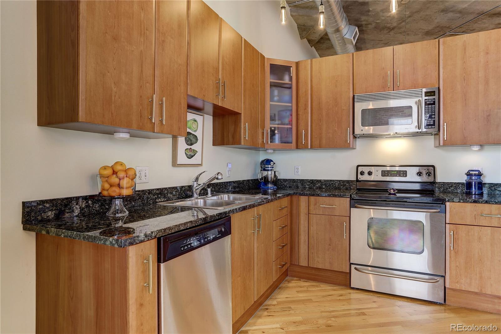 2500 Walnut Street, Unit 212 Denver, CO 80205 - Photo 27 of 39 a kitchen with stainless steel appliances granite countertop a sink stove and refrigerator