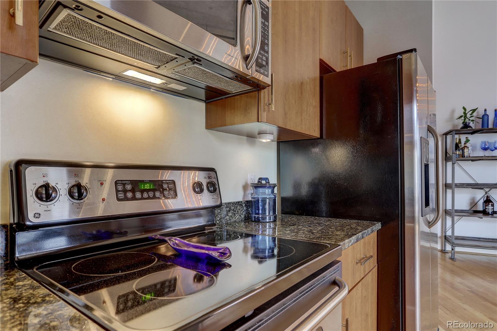 2500 Walnut Street, Unit 212 Denver, CO 80205 - Photo 29 of 39 a kitchen with a stove and a refrigerator