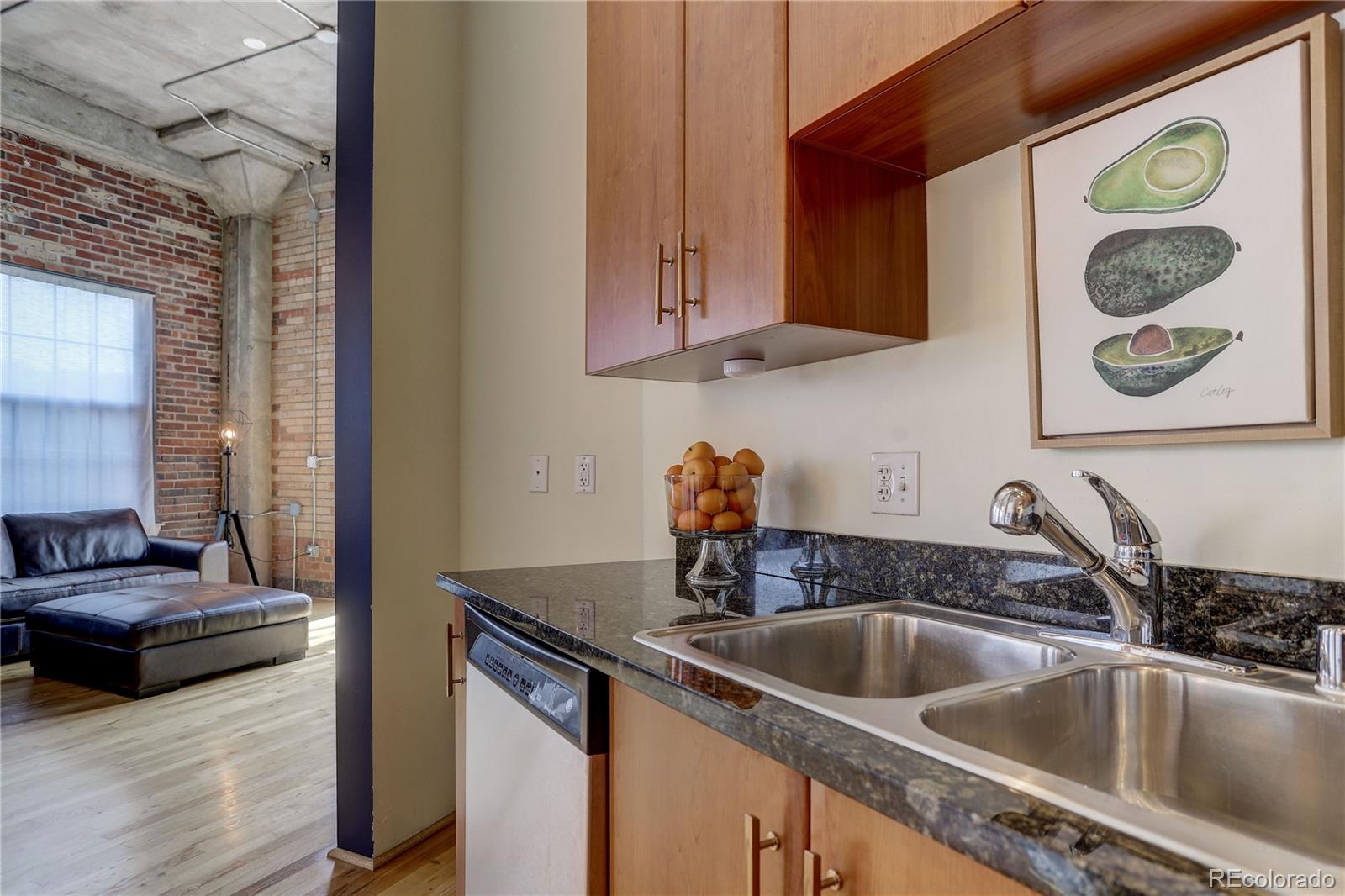 2500 Walnut Street, Unit 212 Denver, CO 80205 - Photo 30 of 39 a kitchen with a sink and a stove with wooden floor