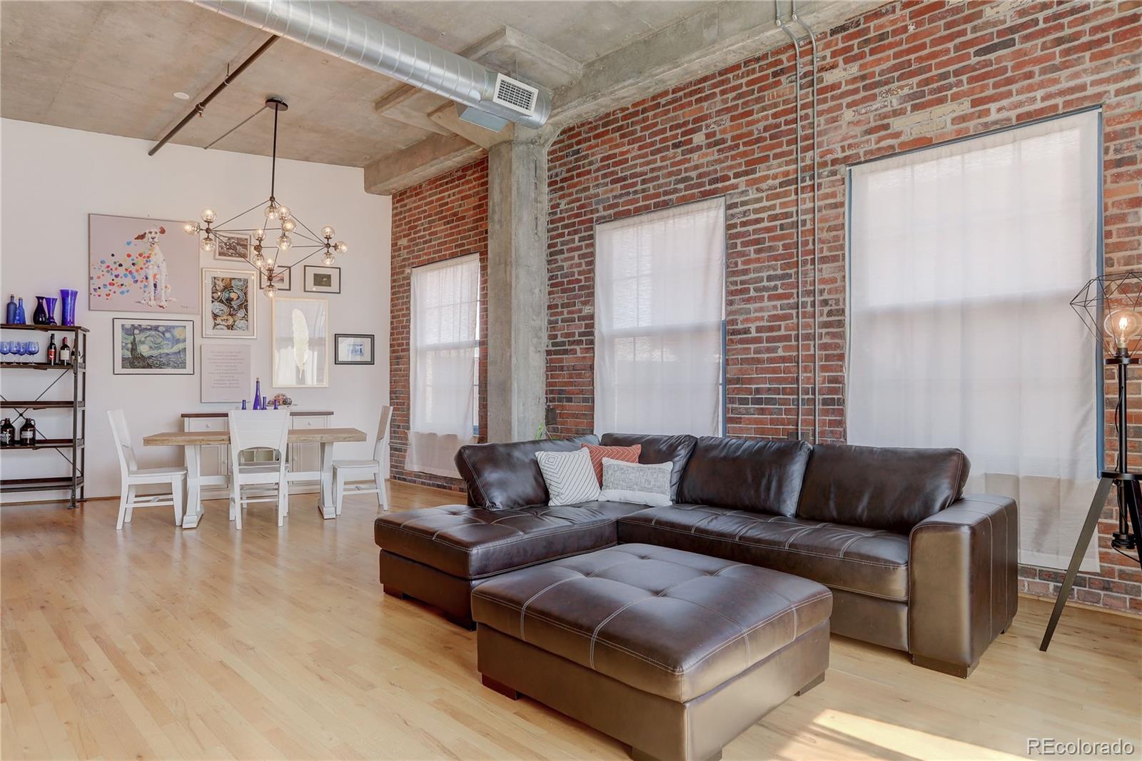 2500 Walnut Street, Unit 212 Denver, CO 80205 - Photo 31 of 39 a living room with furniture and wooden floor