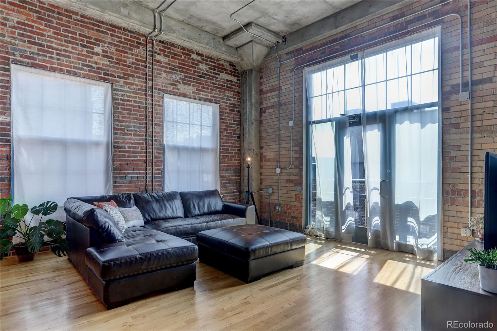 2500 Walnut Street, Unit 212 Denver, CO 80205 - Photo 33 of 39 a living room with furniture and large windows