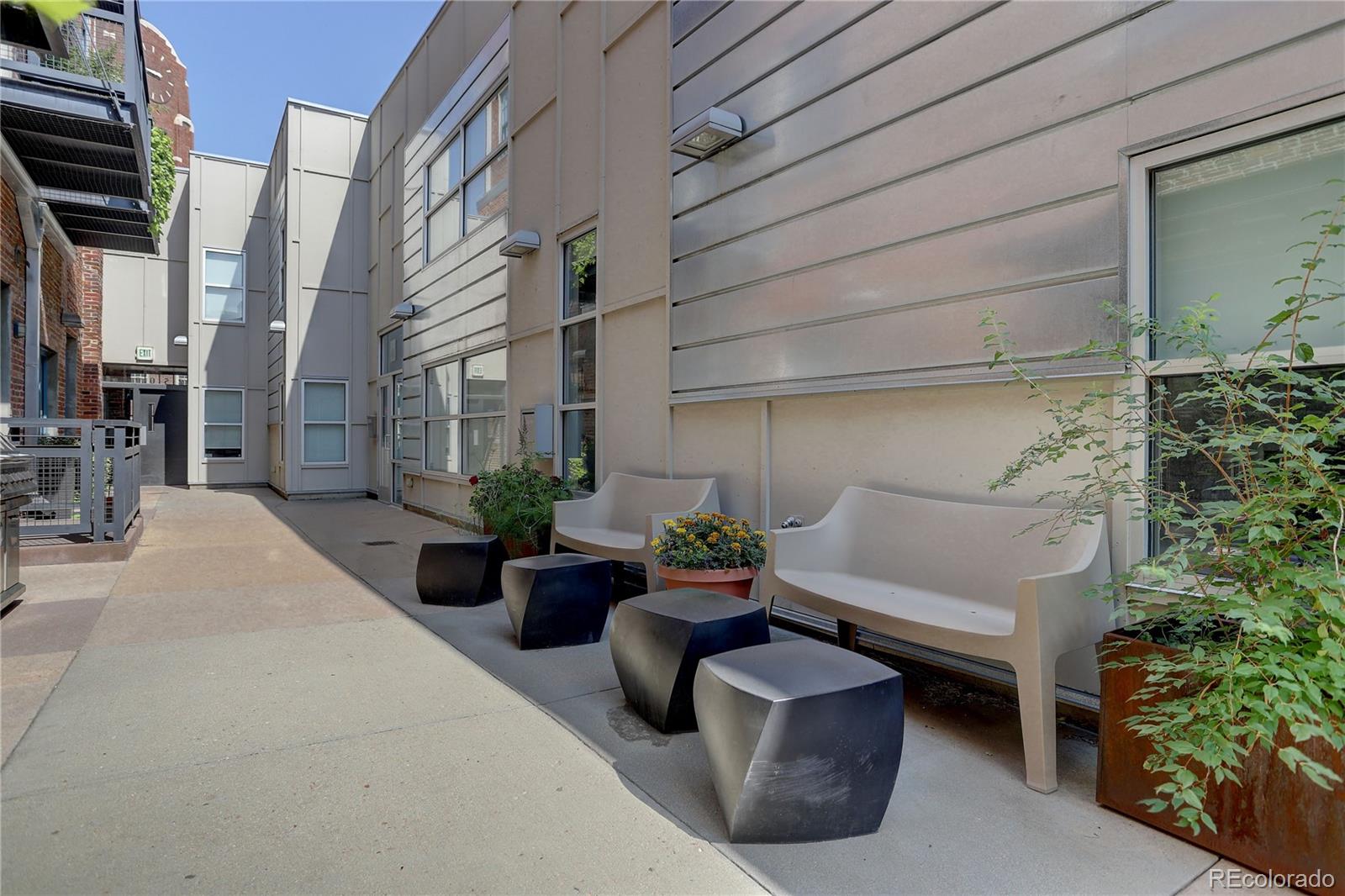 2500 Walnut Street, Unit 212 Denver, CO 80205 - Photo 6 of 39 a view of a patio with couches and potted plants