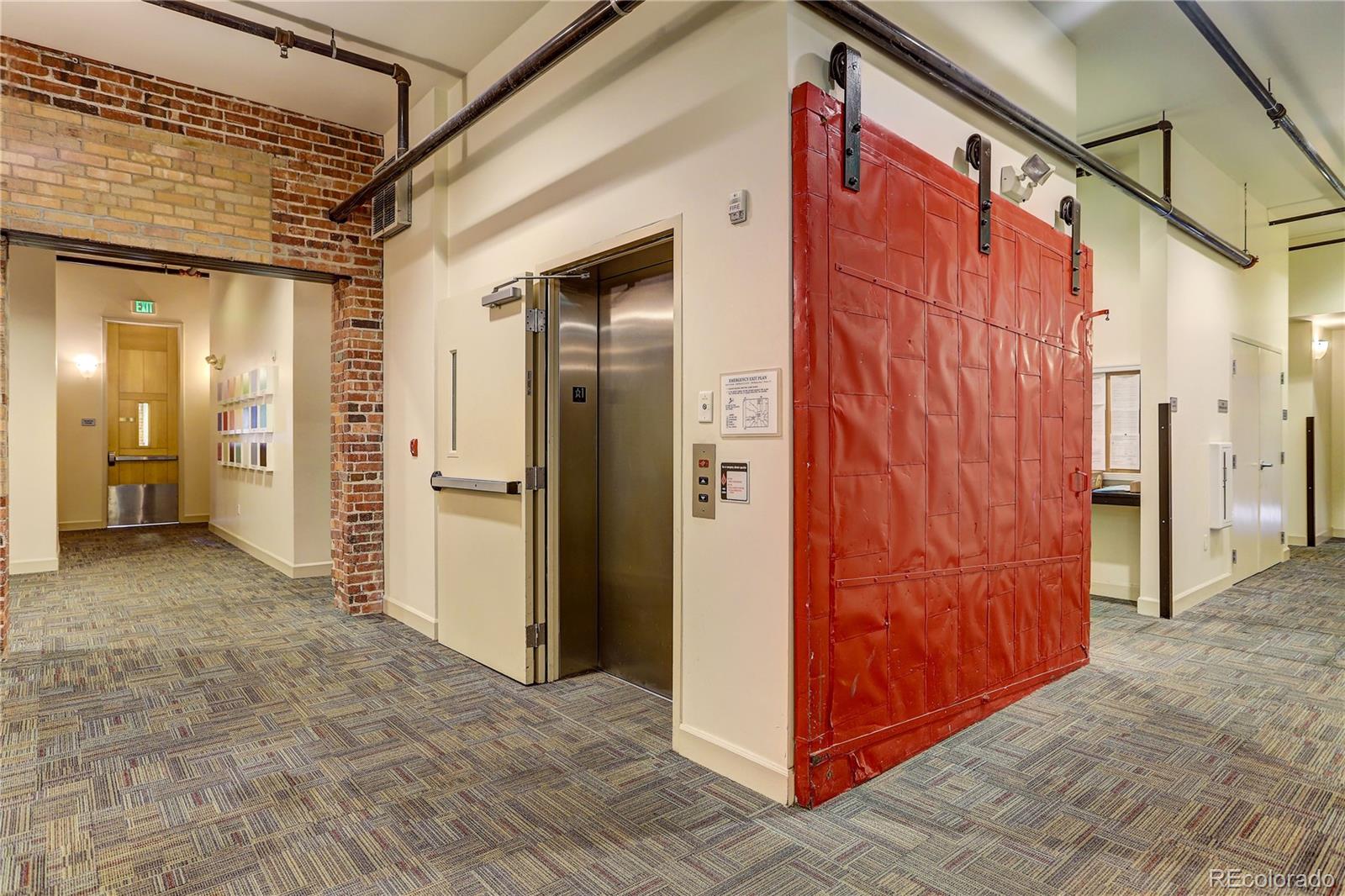 2500 Walnut Street, Unit 212 Denver, CO 80205 - Photo 8 of 39 a view of a hallway with wooden walls