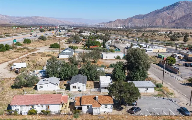 a view of a white house next to a yard