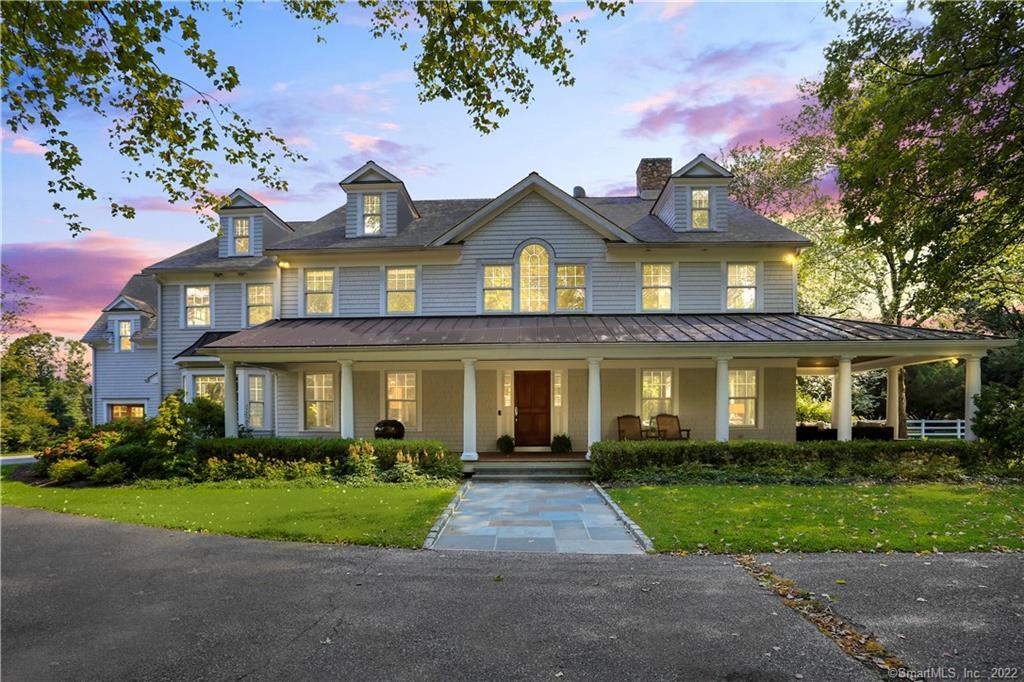 a front view of a house with a garden and yard