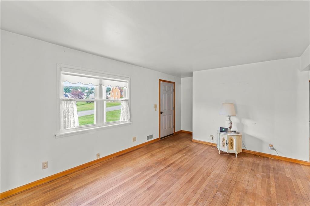17 Ellen Drive McKees Rocks, PA 15136 - Photo 3 of 31 a view of an empty room with wooden floor and a window