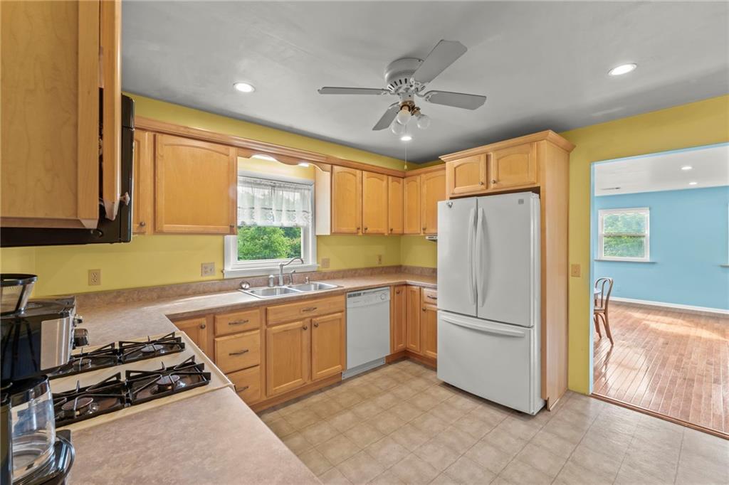 17 Ellen Drive McKees Rocks, PA 15136 - Photo 8 of 31 a kitchen with a refrigerator a sink cabinets and wooden floor