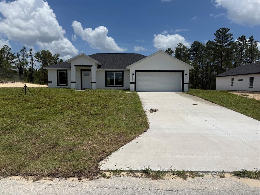 12847 Southwest 84th Terrace Road Ocala, FL 34473 - Photo 1 of 16 a front view of a house with garden
