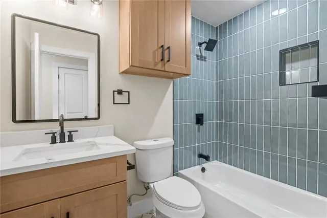 an empty room with a window and a ceiling fan