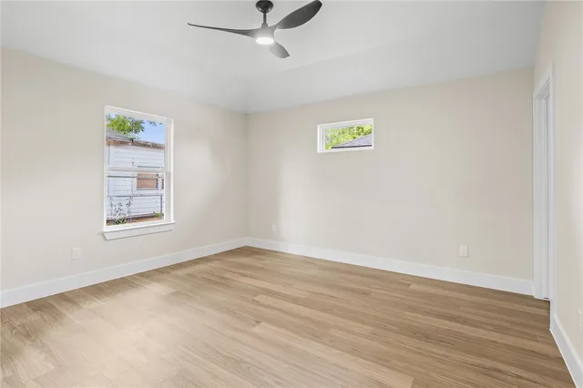 a view of empty room with wooden floor