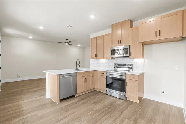 a kitchen with a sink cabinets and stainless steel appliances