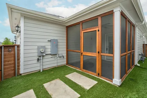 a view of a backyard with chair and a garden