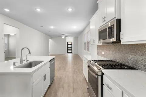 a kitchen that has a sink and a stove