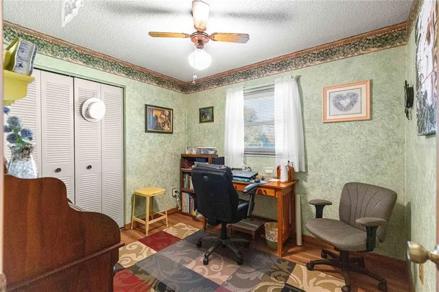 a view of a workspace with furniture and a window