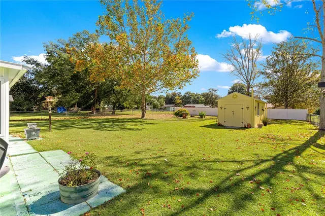 a swimming pool with yard and outdoor seating