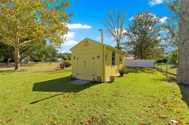 a yellow house with trees in front of it