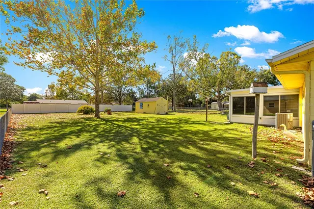 a swimming pool with trees in the background
