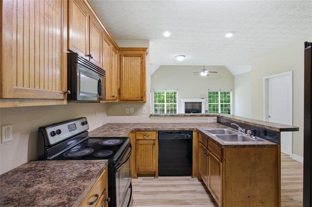 1231 Hillview Road Hampton, GA 30228 - Photo 10 of 49 a kitchen with stainless steel appliances granite countertop a sink stove and cabinets