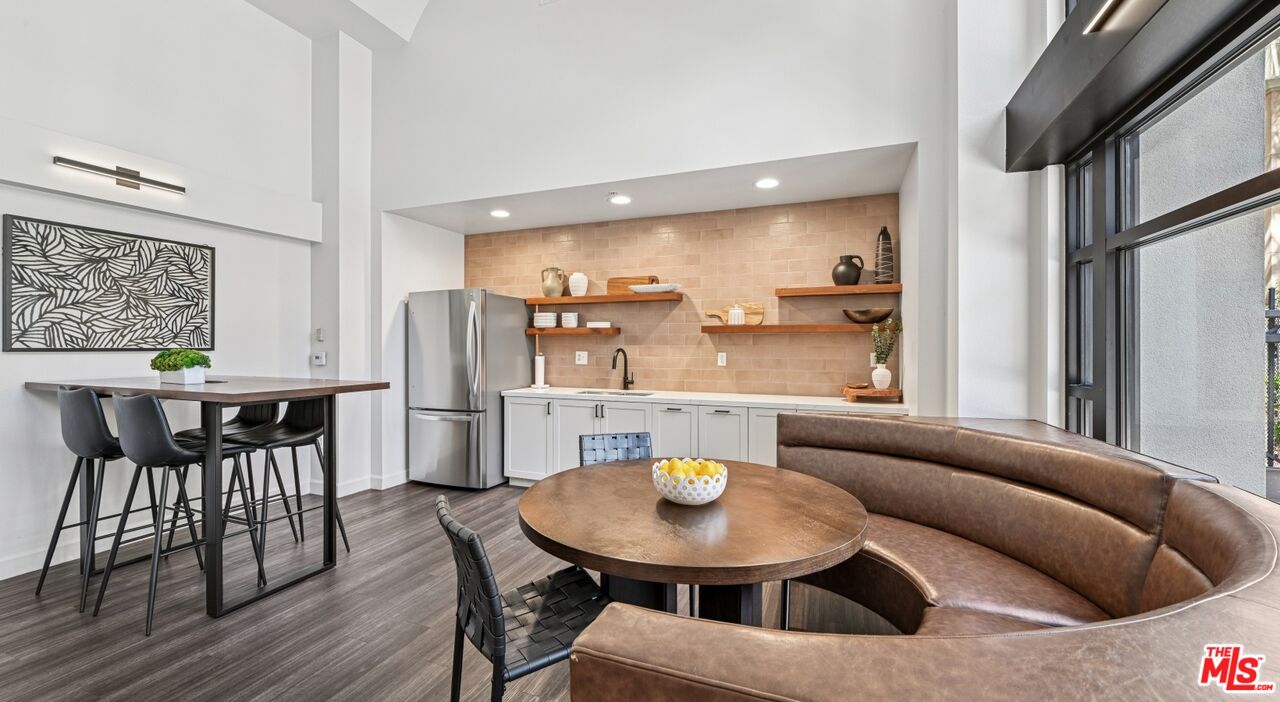 290 North Hudson Avenue, Unit 102W Pasadena, CA 91101 - Photo 9 of 21 a view of a dining room with furniture and wooden floor