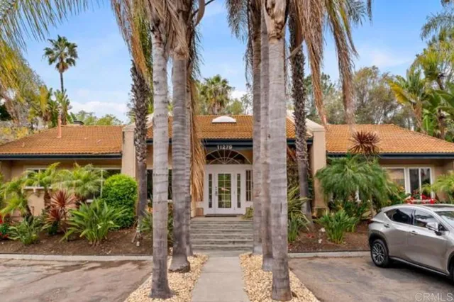 a view of house with outdoor space and swimming pool