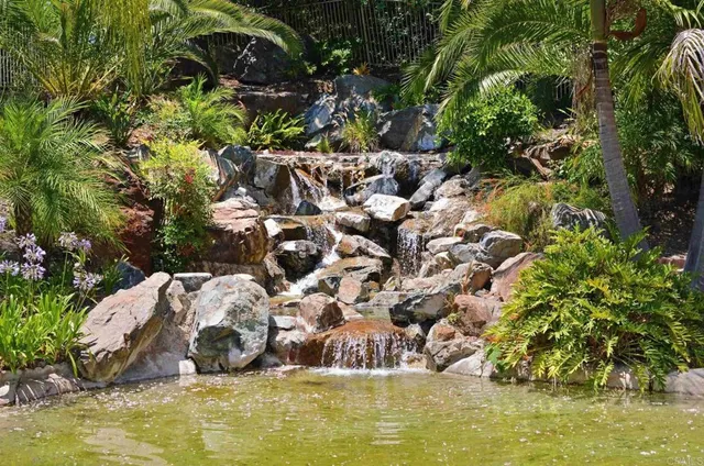 a swimming pool with trees in the background