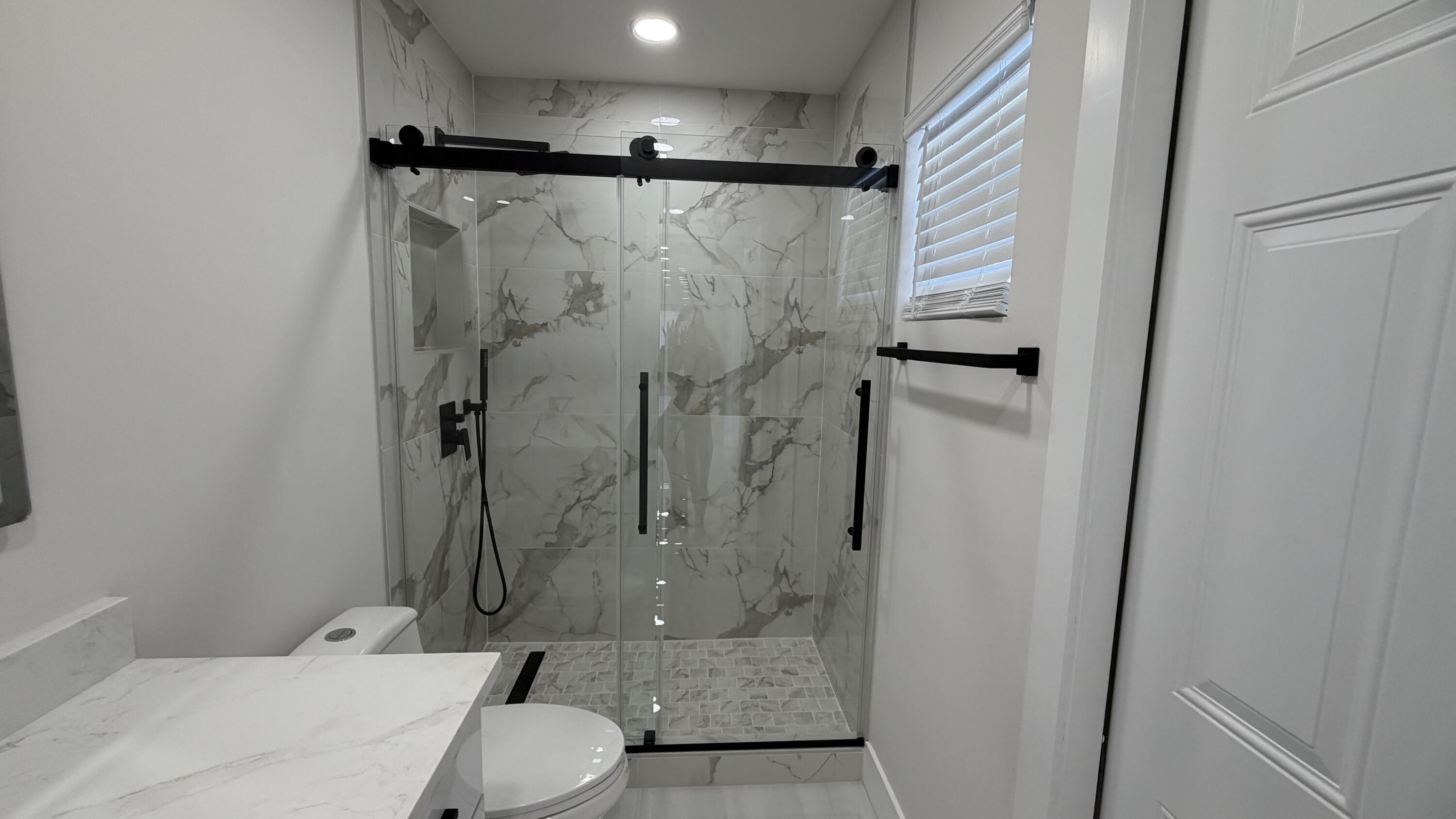 2521 Northeast 45th Street Lighthouse Point, FL 33064 - Photo 21 of 25 a bathroom with a shower toilet and sink
