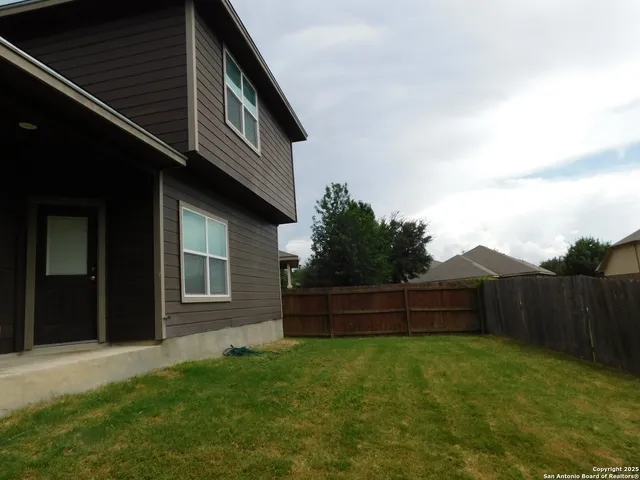 a backyard of a house with lots of green space