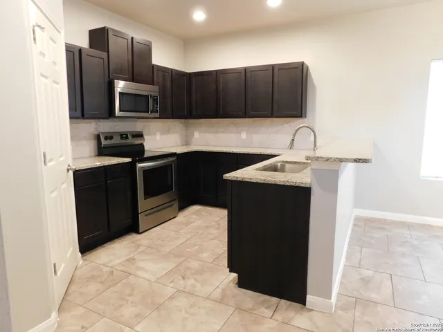 a kitchen with a sink and cabinets