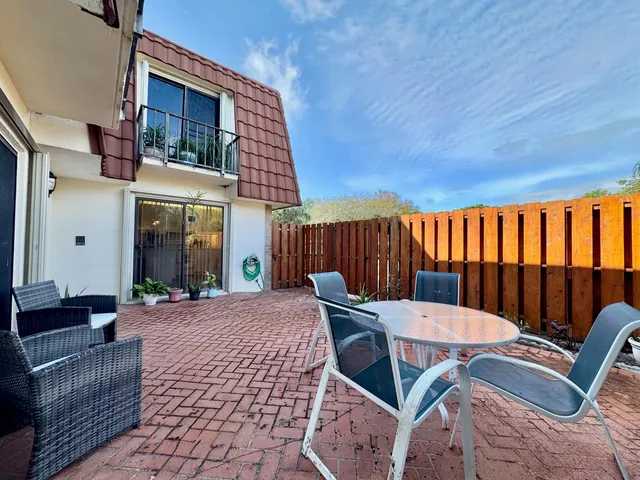 a view of a patio with a table and chairs