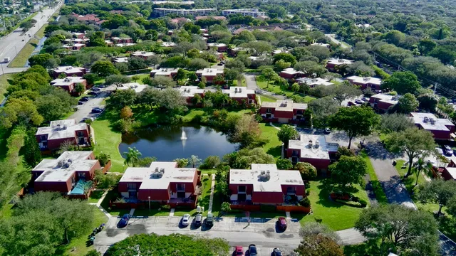 an aerial view of a houses with yard