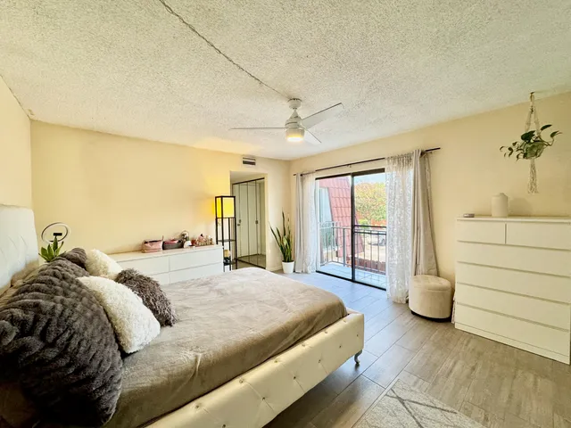 a spacious bedroom with a bed and a large window